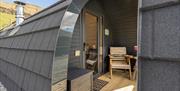 Entrance and outdoor seating of a pod at The Yan Glamping in Grasmere, Lake District