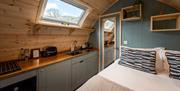 Bed and kitchenette at The Yan Glamping in Grasmere, Lake District