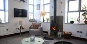Living area with wood burner at The Dairy at Brackenthwaite Farm near Arnside, Cumbria
