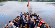 Wedding party on the stern of a heritage vessel, Ullswater 'Steamers', Cumbria.