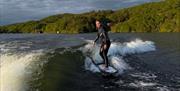 Visitor on a wakeboarding experience with Wake District on Lake Windermere in the Lake District, Cumbria