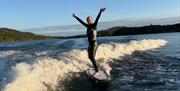 Visitor on a wakeboarding experience with Wake District on Lake Windermere in the Lake District, Cumbria