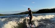 Visitor on a wakeboarding experience with Wake District on Lake Windermere in the Lake District, Cumbria