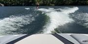 Visitor on a wakeboarding experience with Wake District on Lake Windermere in the Lake District, Cumbria