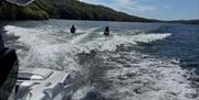 Visitors on a wakeboarding experience with Wake District on Lake Windermere in the Lake District, Cumbria