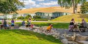 Children playing near Lodges and Holiday Homes at Waters Edge Caravan Park in Crooklands, Cumbria