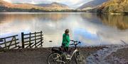 Cyclist Standing Lakeside on a Cycling Holiday in the Lake District, Cumbria from The Carter Company