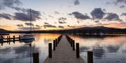 View from a Jetty over Windermere with a Dramatic Sunset in the Lake District, Cumbria