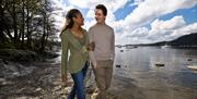 Couple Walking on the Shores of Lake Windermere in the Lake District, Cumbria