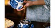 Employee pouring tea from a china teaset at an Exclusive Experience at Wordsworth Grasmere in the Lake District, Cumbria ©Copyright Gareth Gardner 201
