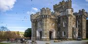 Exterior and picnic tables at Wray Castle, Low Wray, Ambleside, Lake District