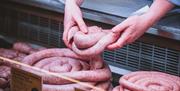 Thick Cumberland sausage in counter at Cranstons Food Hall in Cumbria