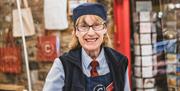 Staff member Anne working on tills at Cranstons Orton Grange Food Hall near Carlisle, Cumbria
