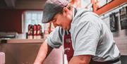 Ian Haworth cutting meat at Cranstons Brampton Food Hall in Brampton, Cumbria