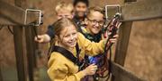 Children on the Climbing Course at Go Ape in Grizedale Forest in the Lake District, Cumbria