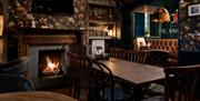 Dining room seating with real log burner at The Angel Inn in Bowness-on-Windermere, Lake District