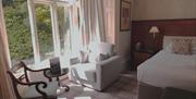 Bedroom seating and decor at Ambleside Manor Vegetarian Guest House in Ambleside, Lake District