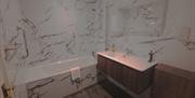 Bathroom with tub at Ambleside Manor Vegetarian Guest House in Ambleside, Lake District