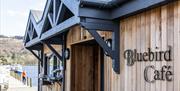 Exterior, jetty, and signage at The Bluebird Cafe in Coniston, Lake District