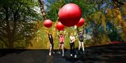 Visitors at Treetop Nets at Zip World Windermere in the Lake District, Cumbria