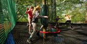 Visitors at Treetop Nets at Zip World Windermere in the Lake District, Cumbria
