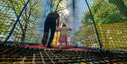 Visitors at Treetop Nets at Zip World Windermere in the Lake District, Cumbria