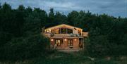 Exterior of Luna Treehouse at Into the Woods at nighttime near Little Salkeld, Cumbria