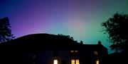 Aurora seen in dark skies over Mosedale End Farm B&B and Glamping Pod in the Lake District, Cumbria