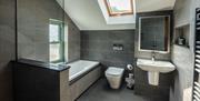 Bathroom with tub, shower, toilet and sink at Ellenboro House in Newton-in-Cartmel, Lake District