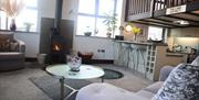 Living area with wood burner at The Dairy at Brackenthwaite Farm near Arnside, Cumbria