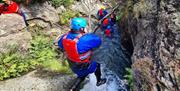 Visitors ghyll scrambling with Newlands Adventure Centre in the Lake District, Cumbria