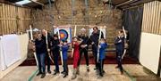 Family doing archery at Newlands Adventure Centre in the Lake District, Cumbria