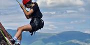 Visitor rock climbing with Newlands Adventure Centre in the Lake District, Cumbria