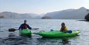 Visitors in kayaks from Newlands Adventure Centre in the Lake District, Cumbria
