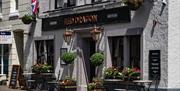 Exterior signage and outdoor seating at the Red Dragon Inn in Kirkby Lonsdale, Cumbria