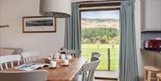 Dining table and scenic views at Rigg Barn at Fornside Farm Cottages in St Johns-in-the-Vale, Lake District © Jo Crompton Photography