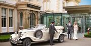 Driver from Lakeland Chauffeurs arrives with a wedding vehicle at a wedding venue for the bridal couple