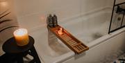 Bath with candles at The Pheasant Lodge near Grange-over-Sands, Cumbria