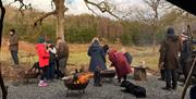 Visitors at a bushcraft experience with Graythwaite Adventure Near Hawkshead, Lake District