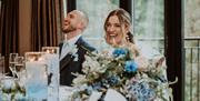 Bridal couple at wedding breakfast at Heather Glen Country House in Ainstable, Cumbria