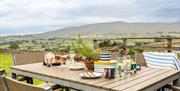 Patio dining and scenic view at The Hare, available through holidaylodges.co.uk in the Lake District, Cumbria