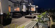 Outdoor seating and entrance at the King Alfred Hotel in Barrow-in-Furness, Cumbria at dusk