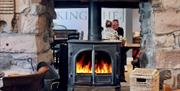 Wood burner in the dining room at The King's Head in Ravenstonedale, Cumbria