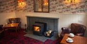 Coffee beside the cosy fireplace at The Lake District Castle Inn Hotel and Spa