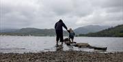 Family exploring the shores of Windermere at BeWILDerwood Lake District in Windermere
