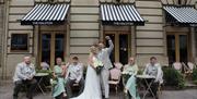 Bridal Couple posing for a photo in front of The Halston in Carlisle, Cumbria