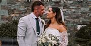 Bridal Couple posing for a photo near The Halston in Carlisle, Cumbria © Beth Faulder Photography