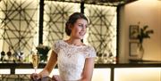 Bride posing for a photo in The Halston in Carlisle, Cumbria © Photography by Helen Whitaker 01228513741