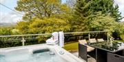 Hot tub and patio at Meadowcroft Cottage in Hillcroft Park Holiday Park in Pooley Bridge, Lake District