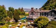 Garden seating and hotel exterior at The Borrowdale Hotel in Borrowdale, Lake District
